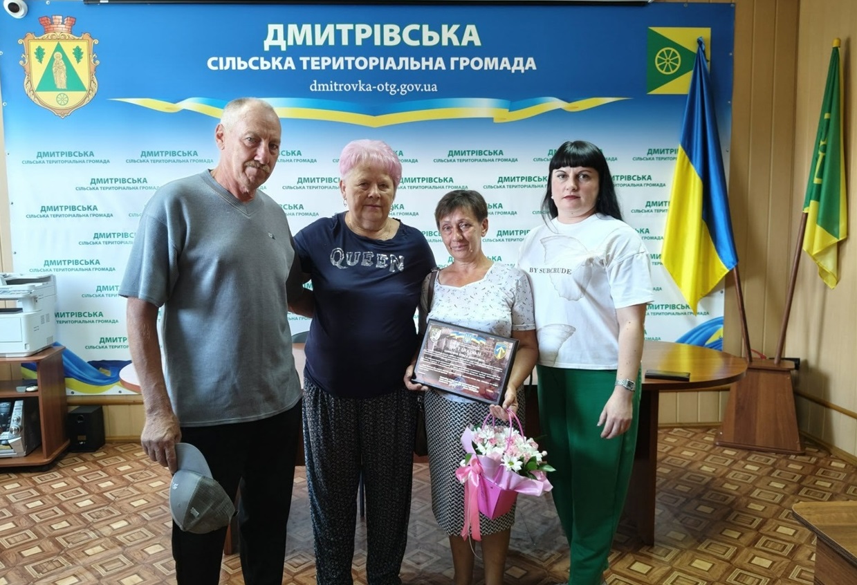 Ольга та Микола Демченки, голова Дмитрівської громади Наталія Стиркуль та секретакр ради Людмила Камінська, під яас врк=учення Подяки від командування 57 окремої мотопіхотної бригади імені кошового отамана Костя Гордієнка