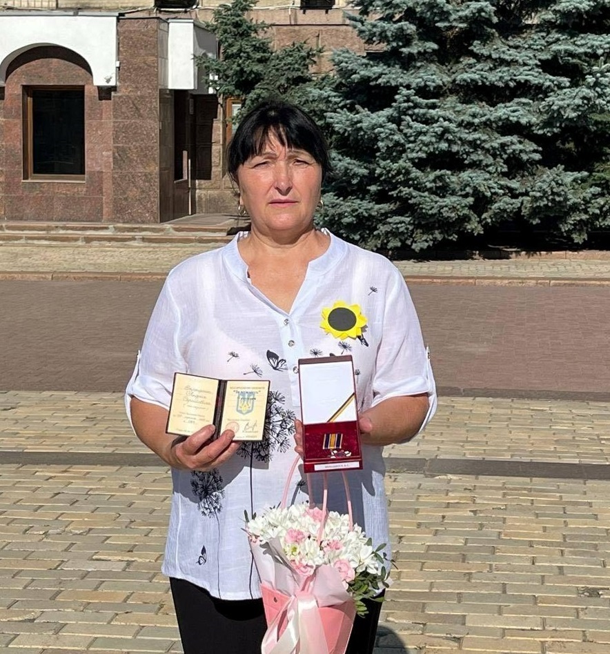 Світлана Зарецька тримає нагороду сина